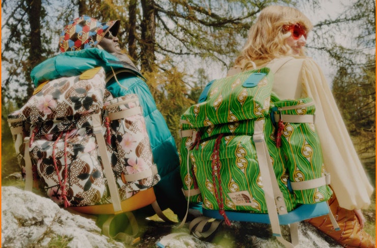 Two people with The North Face x Gucci backpacks on.